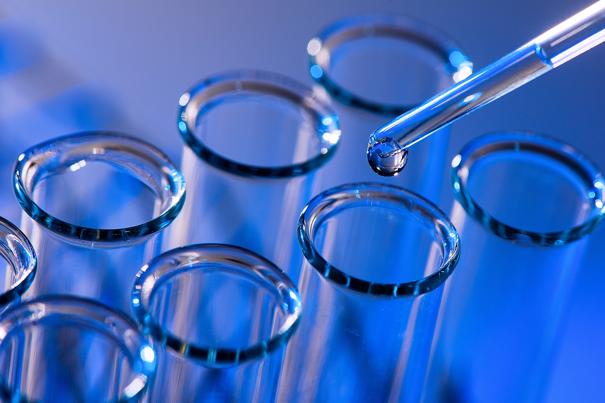 Test tube row. Concept of medical or science laboratory, liquid drop droplet with dropper in blue tone background, close up, micro photography picture. Test tube row